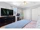 Spacious bedroom featuring a large bed, TV, and ample closet space at 3226 W Girard Ave # D, Englewood, CO 80110