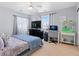 Bright bedroom with a large bed, window, and workspace at 3226 W Girard Ave # D, Englewood, CO 80110