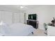 Bright bedroom with neutral walls, ceiling fan, carpet and a dark dresser at 3226 W Girard Ave # D, Englewood, CO 80110