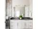 Elegant bathroom with double vanity, stylish mirrors, and tiled shower at 801 8Th St, Golden, CO 80401