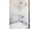 Modern bathtub-shower combo with sliding glass door and tile walls at 801 8Th St, Golden, CO 80401