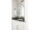 Elegant bathroom with a white vanity, black countertop, and a large mirror at 801 8Th St, Golden, CO 80401