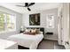Calm bedroom with a plush white comforter, neutral accents, and large windows providing plenty of natural light at 801 8Th St, Golden, CO 80401