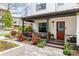 Inviting front porch with orange seating, gray pavers, and a red door with the house number at 801 8Th St, Golden, CO 80401