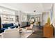 Open-concept living room and kitchen with hardwood floors, blue sofa, and stainless steel appliances at 801 8Th St, Golden, CO 80401