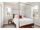 Bright main bedroom featuring four-poster bed frame and mountain views at 801 8Th St, Golden, CO 80401