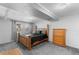 Neutral bedroom with carpet floor, beam, window and a wood dresser at 8010 W Chestnut Dr, Littleton, CO 80128