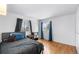 Bedroom with hardwood floors, double windows and dark blue curtains at 8010 W Chestnut Dr, Littleton, CO 80128