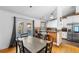 Kitchen and dining area with hardwood floors and access to a deck at 8010 W Chestnut Dr, Littleton, CO 80128