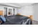 Spacious bedroom featuring neutral walls, carpet flooring, and a view into a secondary bedroom at 8010 W Chestnut Dr, Littleton, CO 80128