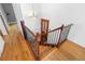 Wooden staircase with wrought-iron railings leading to the upper level at 8010 W Chestnut Dr, Littleton, CO 80128