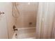 Clean bathroom with shower/tub combo and white tiled walls at 6839 E Briarwood Dr, Centennial, CO 80112