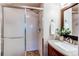 Bathroom featuring a glass-enclosed shower, granite vanity, and stylish fixtures at 6839 E Briarwood Dr, Centennial, CO 80112