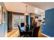 Bright dining area with sliding glass door to patio, hardwood floors, and a view to the kitchen at 6839 E Briarwood Dr, Centennial, CO 80112