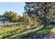 A lush green space features mature trees and a creek, offering a serene natural environment at 6839 E Briarwood Dr, Centennial, CO 80112