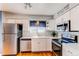 Kitchen with white cabinets, stainless steel appliances, and hardwood floors at 6839 E Briarwood Dr, Centennial, CO 80112