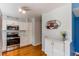 Kitchen with white cabinets, stainless steel appliances, and hardwood floors at 6839 E Briarwood Dr, Centennial, CO 80112