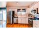 Bright kitchen with stainless steel appliances, white cabinetry, and hardwood flooring at 6839 E Briarwood Dr, Centennial, CO 80112