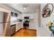 Kitchen with white cabinets, stainless steel appliances, and hardwood floors at 6839 E Briarwood Dr, Centennial, CO 80112