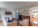 Bright living room featuring a brick fireplace, stylish decor, and hardwood floors at 6839 E Briarwood Dr, Centennial, CO 80112