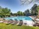 A large community swimming pool is surrounded by lounge chairs, perfect for relaxation and recreation at 6839 E Briarwood Dr, Centennial, CO 80112