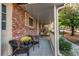 Inviting covered porch with brick detail and cozy seating perfect for relaxing outdoors at 6839 E Briarwood Dr, Centennial, CO 80112