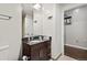 Bathroom features a dark wood vanity, a granite countertop, and a modern faucet at 891 14Th St # 2712, Denver, CO 80202