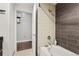 Bathroom with ceramic wall tiles around a white soaking tub and shower at 891 14Th St # 2712, Denver, CO 80202