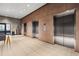 Hallway featuring wood walls and several elevators for easy access to all floors at 891 14Th St # 2712, Denver, CO 80202