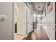 Long hallway with hardwood floors leading to the living area and adjacent bathroom at 891 14Th St # 2712, Denver, CO 80202