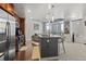 Open kitchen with stainless steel appliances and island seating flows into the living area at 891 14Th St # 2712, Denver, CO 80202