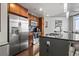 Kitchen with stainless steel appliances, dark wood cabinets and a modern island at 891 14Th St # 2712, Denver, CO 80202