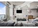 Open living space with balcony access and a flat screen television next to the modern kitchen at 891 14Th St # 2712, Denver, CO 80202