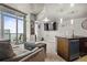 Open living space with access to the balcony, a flat screen TV, and kitchen with island at 891 14Th St # 2712, Denver, CO 80202