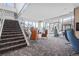 Bright lobby with a staircase, skylight, lounge seating, and oversized windows with an outdoor view at 891 14Th St # 2712, Denver, CO 80202