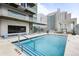 Rooftop swimming pool with lounge seating, a city view, and a modern building exterior at 891 14Th St # 2712, Denver, CO 80202