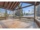 Spacious back porch with wooden floors, railings, exposed beams, and string lights at 27 Buckthorn Dr, Littleton, CO 80127