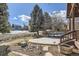 Backyard view with patio and mature trees, creating a serene and private outdoor space at 27 Buckthorn Dr, Littleton, CO 80127