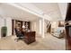 Finished basement featuring a home office space, built-in bookshelves, and staircase with carpet at 27 Buckthorn Dr, Littleton, CO 80127