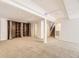 Finished basement featuring neutral carpet, a large bookcase, and recessed lighting at 27 Buckthorn Dr, Littleton, CO 80127