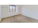 Neutral bedroom with carpeting, a window, and simple shelving at 27 Buckthorn Dr, Littleton, CO 80127