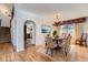 Inviting dining room with a classic chandelier and views of the backyard at 27 Buckthorn Dr, Littleton, CO 80127