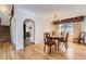 Cozy dining area featuring hardwood floors, arched entryways, and a chandelier, perfect for entertaining at 27 Buckthorn Dr, Littleton, CO 80127