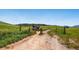 Dirt road through an open field with mountains in the background at Ken Caryl Valley in Littleton, Colorado at 27 Buckthorn Dr, Littleton, CO 80127