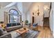 Bright living room featuring a large arched window and elegant chandelier lighting at 27 Buckthorn Dr, Littleton, CO 80127