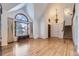 Bright and airy living room with a large arched window, hardwood floors, and a staircase at 27 Buckthorn Dr, Littleton, CO 80127