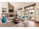 Cozy living room with brick fireplace and view of the outdoor patio at 27 Buckthorn Dr, Littleton, CO 80127