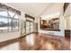 Sunlit living area with hardwood floors, access to a deck, and a view into the kitchen at 27 Buckthorn Dr, Littleton, CO 80127