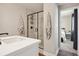 Bathroom featuring a shower with black hardware, gray tile and a white vanity at 9759 Waco St, Commerce City, CO 80022