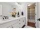 Bathroom featuring a shower-over-tub with black hardware and a double sink vanity at 9759 Waco St, Commerce City, CO 80022
